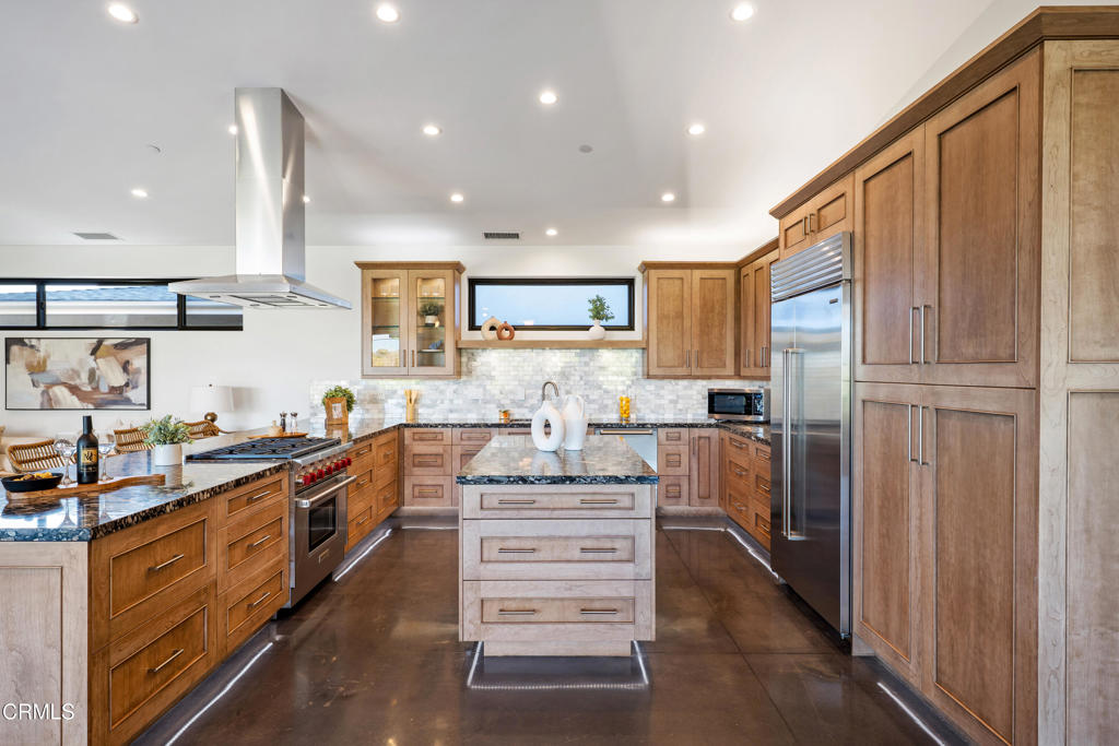 5572 Rainier Street Ventura, CA 93003 - Photo 5 of 29 a kitchen with stainless steel appliances kitchen island granite countertop a refrigerator and a stove top oven