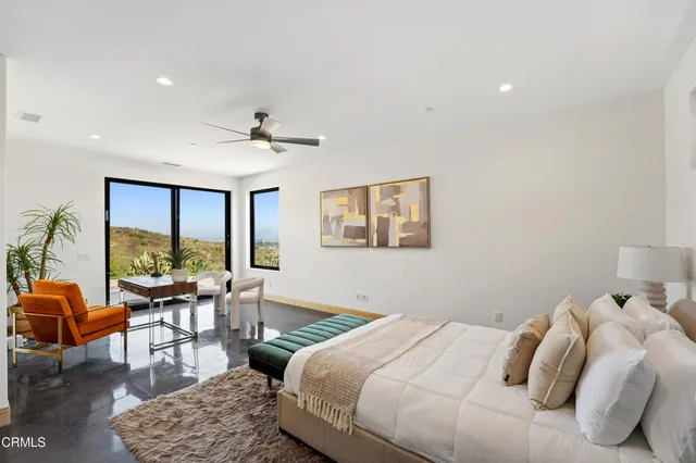 a bedroom with a bed and a couch