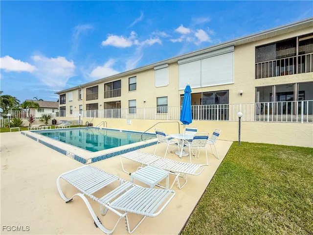 a view of a house with swimming pool and sitting area