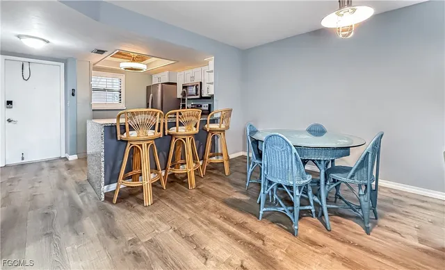 a view of a dining room with furniture window and wooden floor