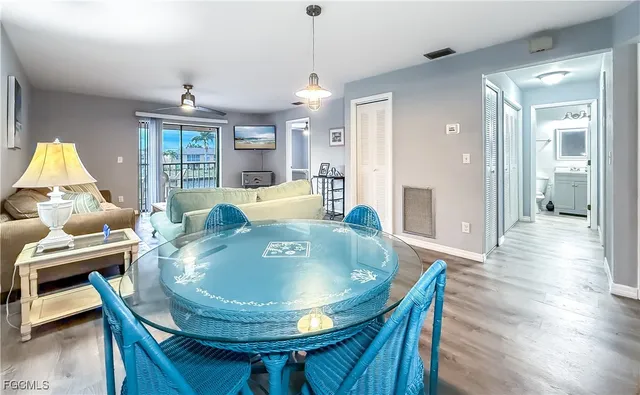 a dining room with furniture window and wooden floor