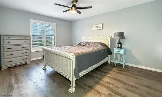 a bed sitting in a bedroom next to a window