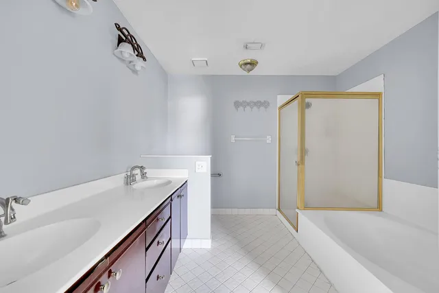 a bathroom with a sink a vanity and a bathtub