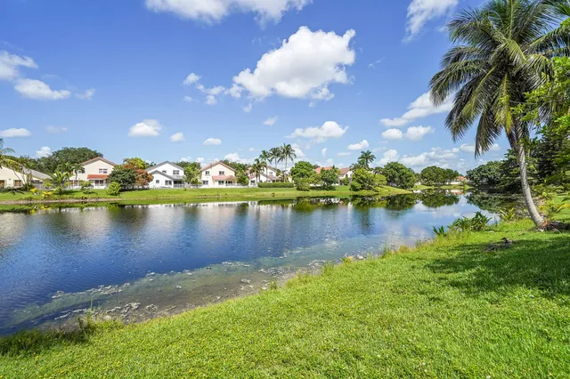 a view of a lake with houses in the background