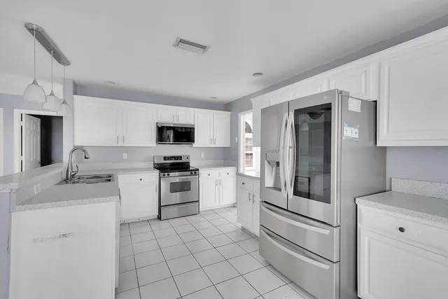 a kitchen with a stove sink and refrigerator