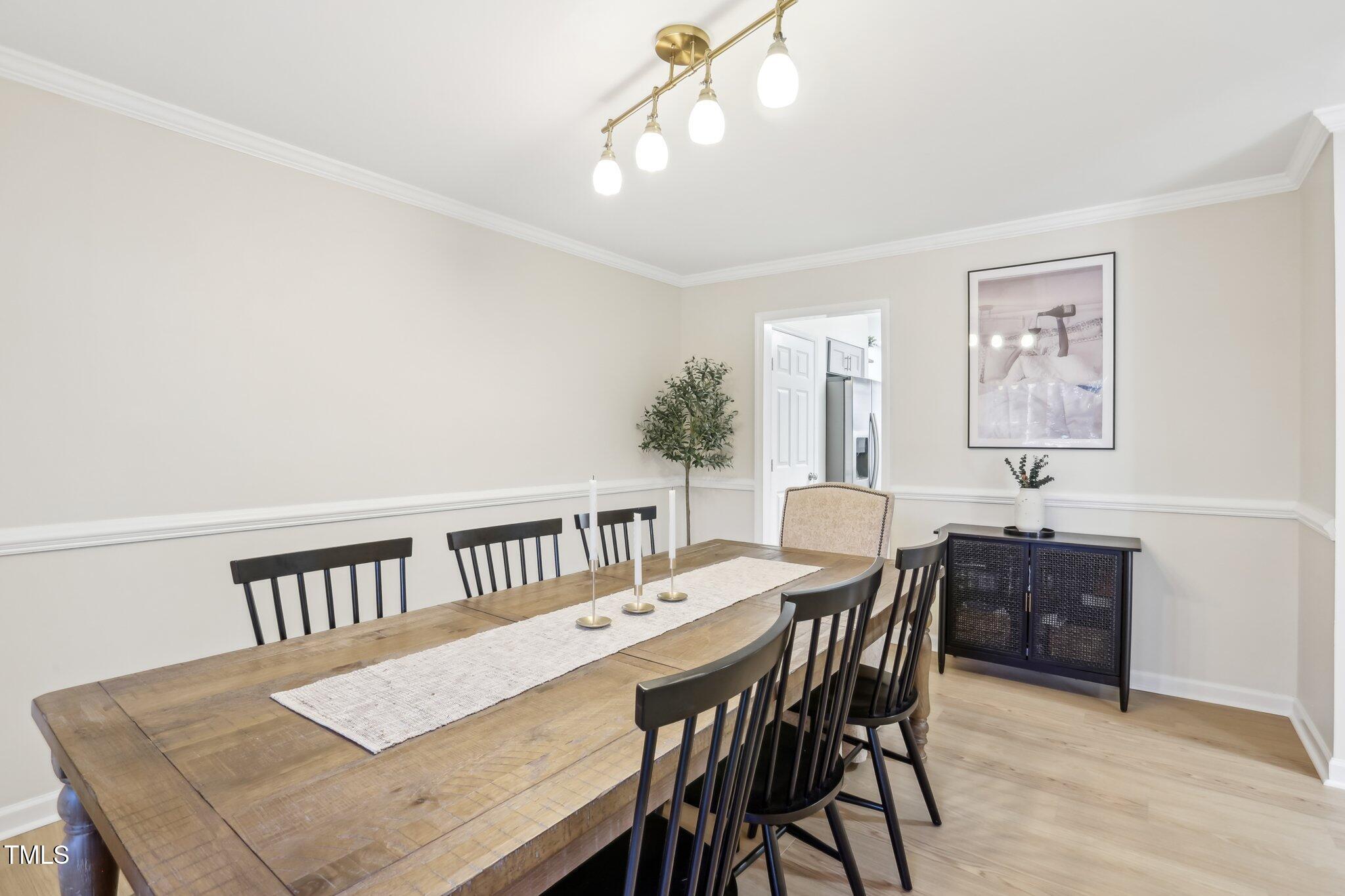 5902 Carmel Lane Raleigh, NC 27609 - Photo 7 of 37 a view of a dining room with furniture and wooden floor