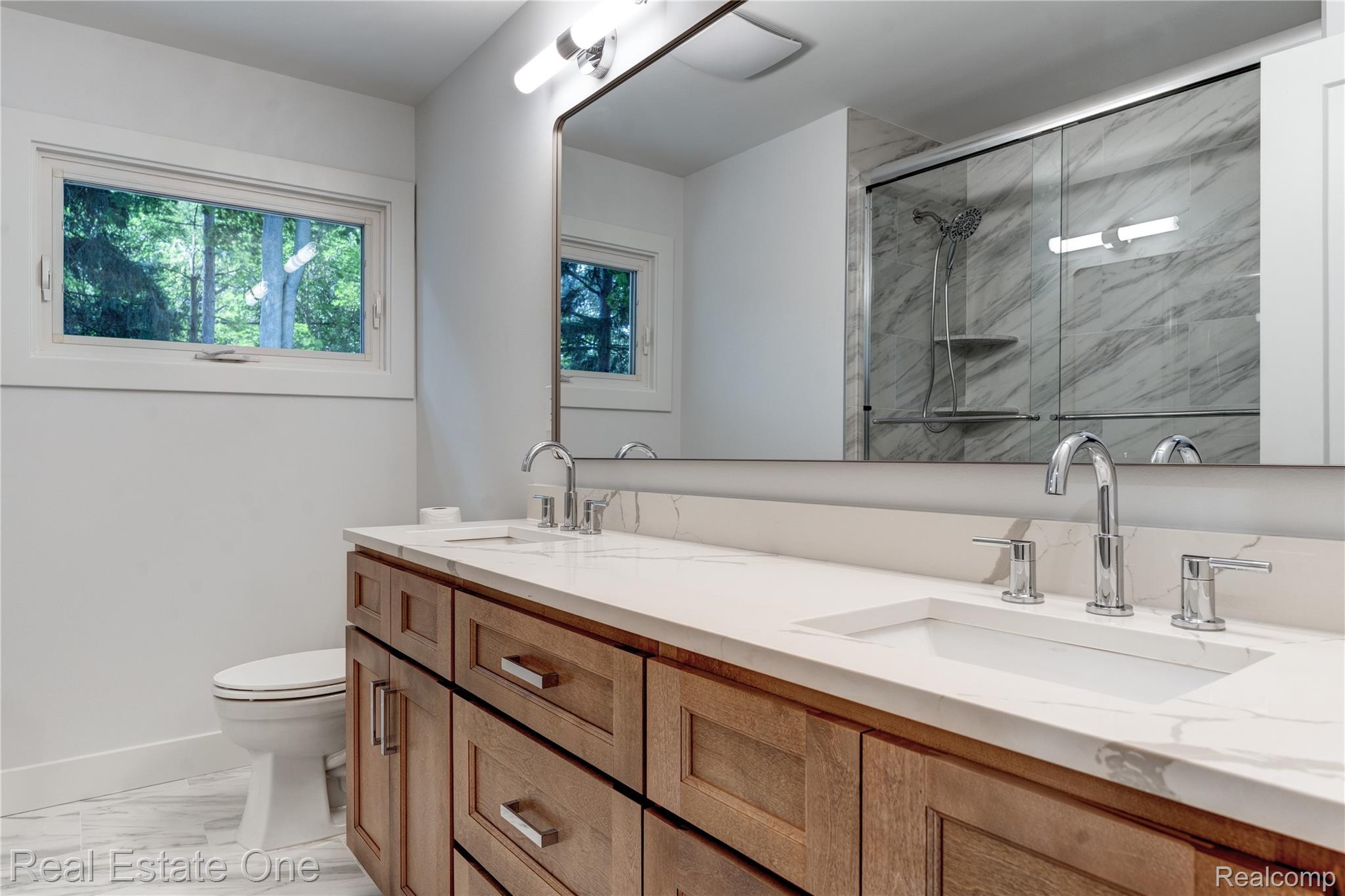 786 South Cranbrook Road Bloomfield Hills, MI 48301 - Photo 19 of 38 Bathroom featuring a marble finish shower, double vanity, and light marble finish floors