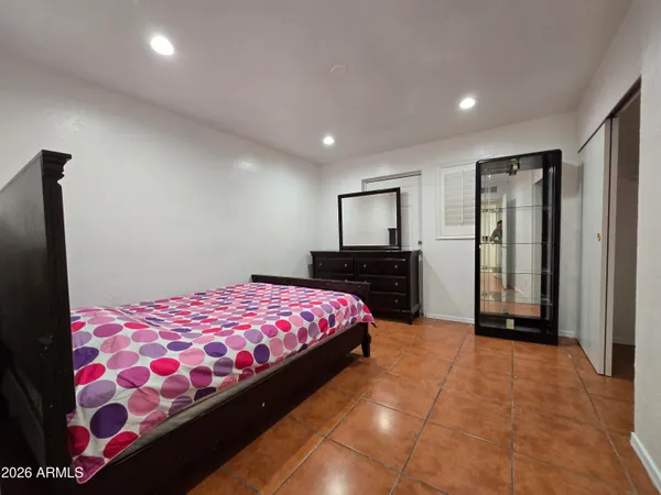 a bedroom with a bed and a closet