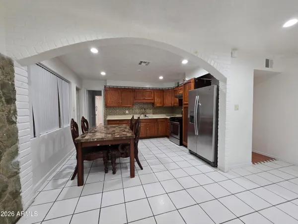 a kitchen with a table and chairs