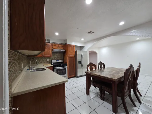a kitchen with sink cabinets and dining table
