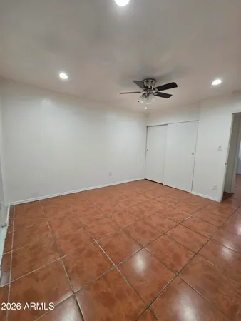 a view of a room with a ceiling fan