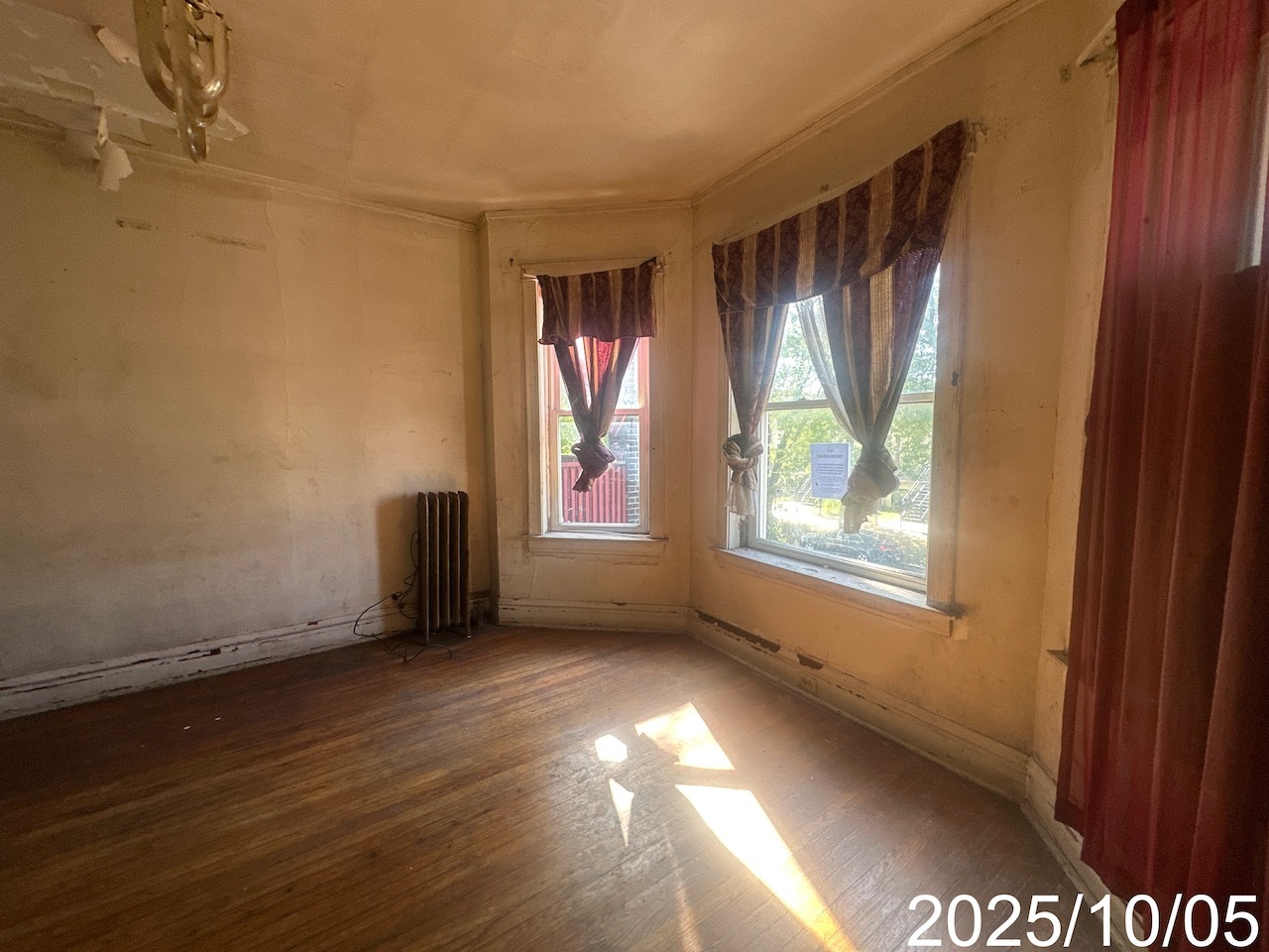 7435 South Wentworth Avenue Chicago, IL 60621 - Photo 13 of 18 a view of an empty room with wooden floor and a window