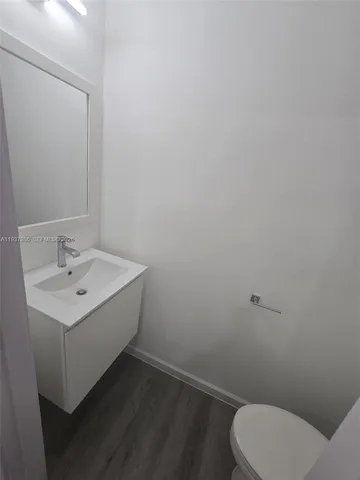 a bathroom with a sink toilet and mirror