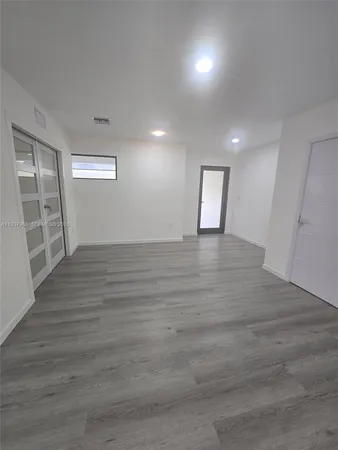 a view of an empty room and wooden floor
