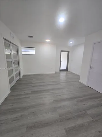 a view of an empty room and wooden floor
