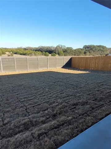 a view of a lake with houses in the back