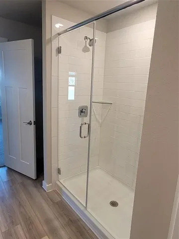 a bathroom with a glass shower door