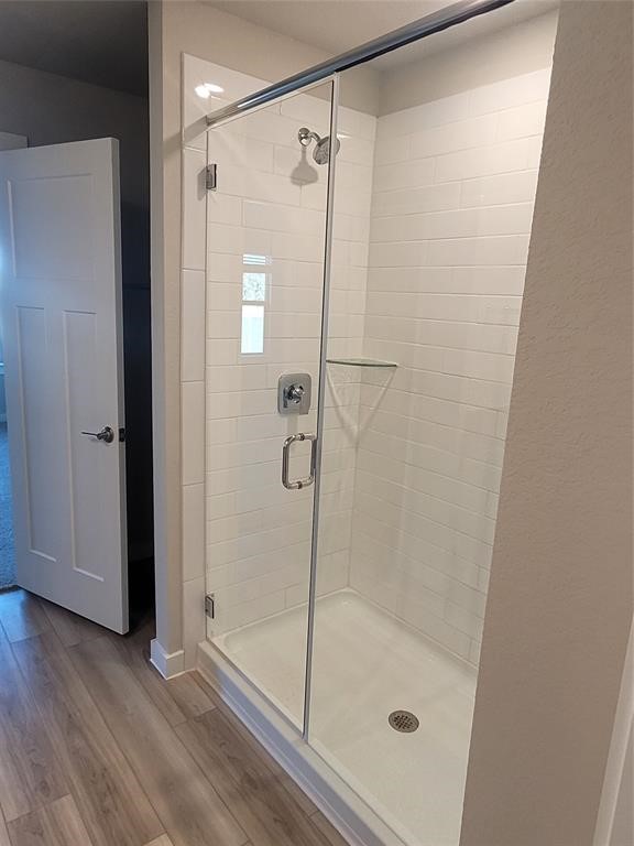 517 Coda Crossing Georgetown, TX 78633 - Photo 3 of 17 a bathroom with a glass shower door