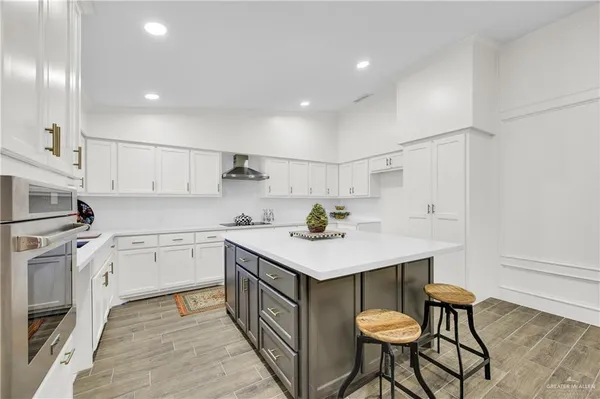 a living room with furniture a table and kitchen view