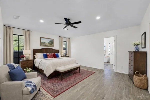 a spacious bathroom with a tub sink and mirror