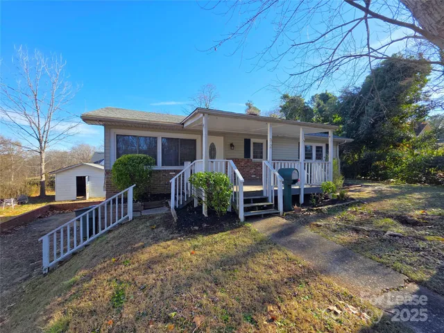 a view of a house with a yard and deck