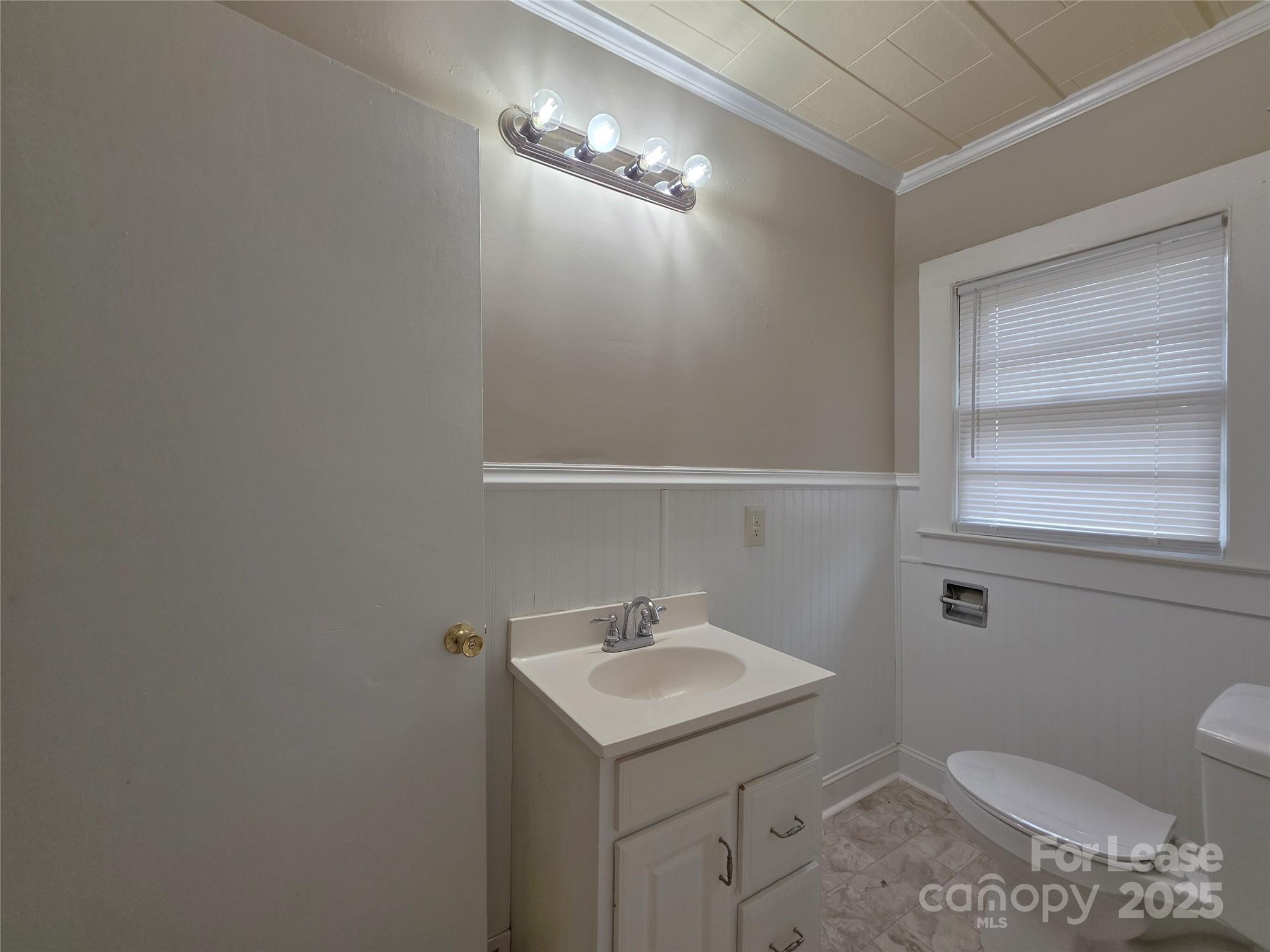 92 Lawndale Avenue Southeast Concord, NC 28025 - Photo 11 of 19 a bathroom with a sink a toilet and a mirror