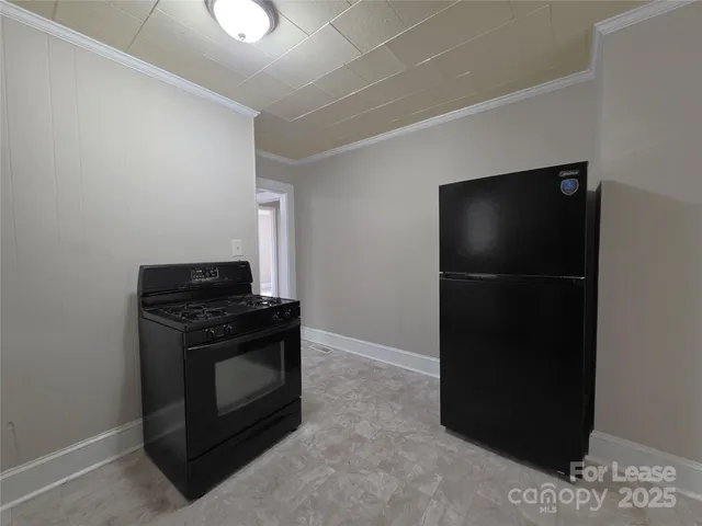 a kitchen with a refrigerator and a stove