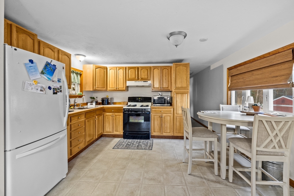 27 Clems Way Acushnet, MA 02743 - Photo 3 of 16 a kitchen with a refrigerator and a stove top oven
