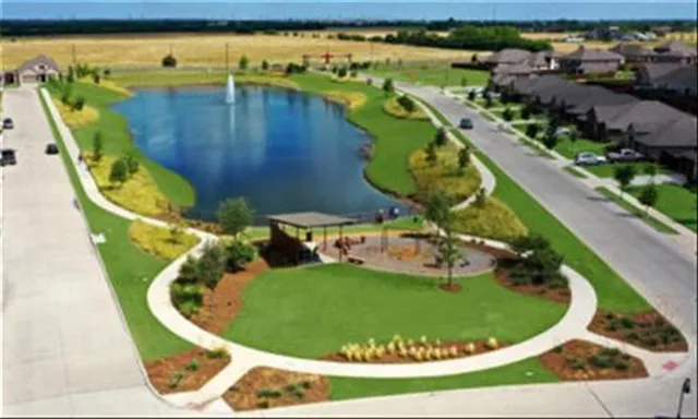 a view of a house with a yard and lake view