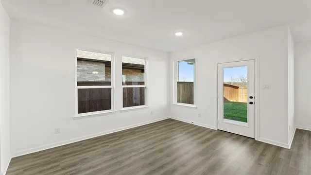 a view of a kitchen with a sink a ceiling fan and kitchen appliances