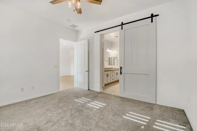 a view of a closet and chandelier fan in a room
