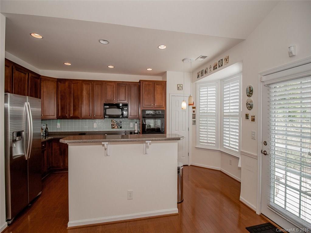 219 Garnet Court, Unit 558 Fort Mill, SC 29708 - Photo 12 of 23 a kitchen with stainless steel appliances granite countertop a refrigerator a sink dishwasher a stove and a refrigerator