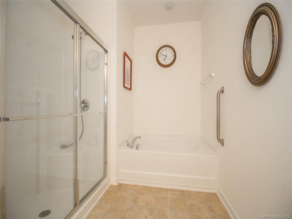 219 Garnet Court, Unit 558 Fort Mill, SC 29708 - Photo 15 of 23 a bathroom with a shower a toilet and a shower