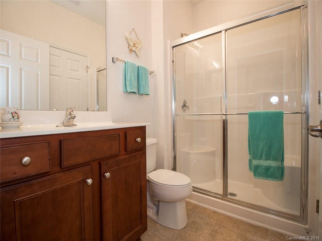 219 Garnet Court, Unit 558 Fort Mill, SC 29708 - Photo 16 of 23 a bathroom with a sink a toilet and shower
