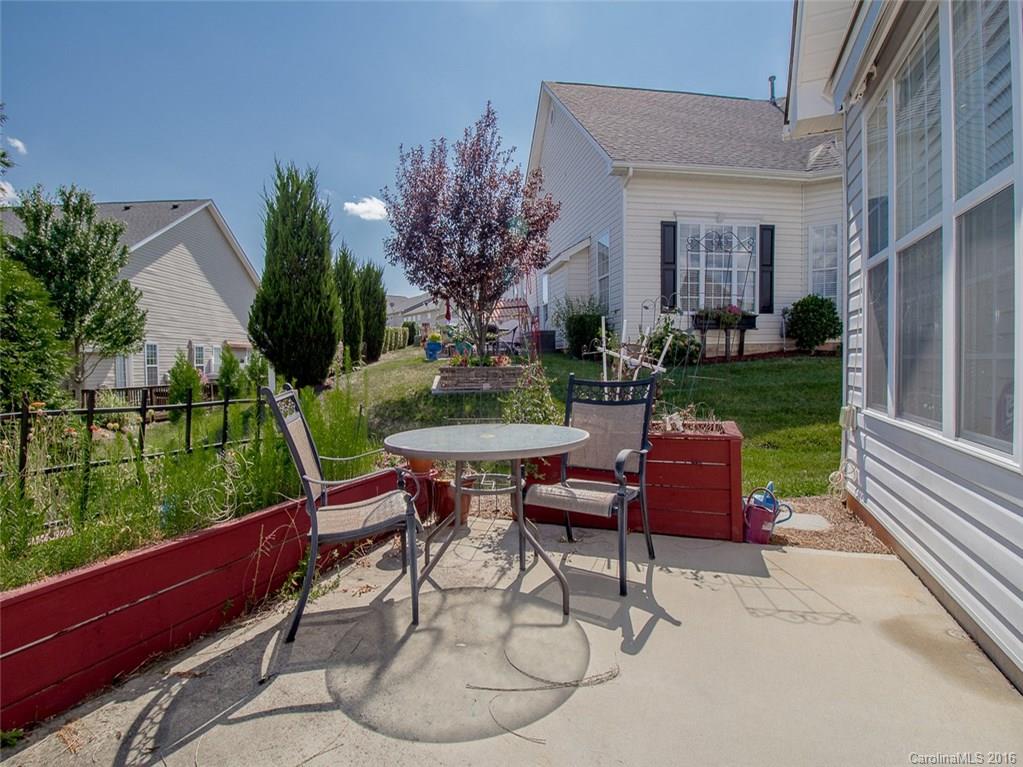 219 Garnet Court, Unit 558 Fort Mill, SC 29708 - Photo 19 of 23 a view of a patio with table and chairs garden and plants