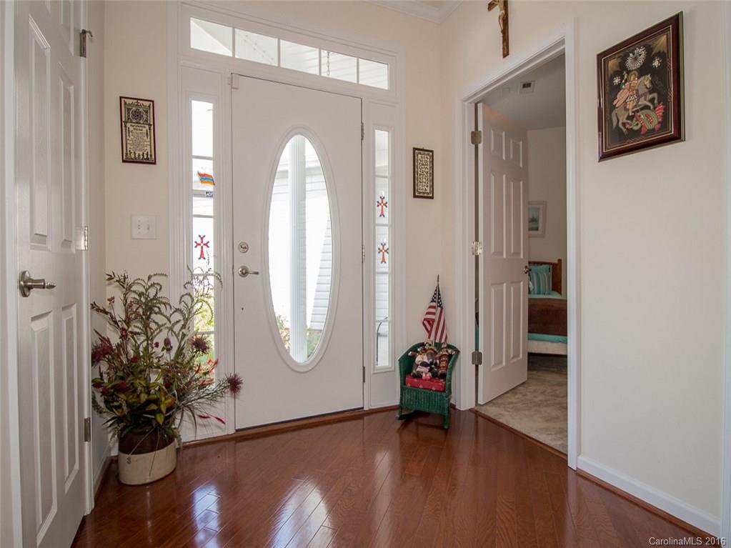 219 Garnet Court, Unit 558 Fort Mill, SC 29708 - Photo 3 of 23 a view of a hallway with wooden floor and a potted plant