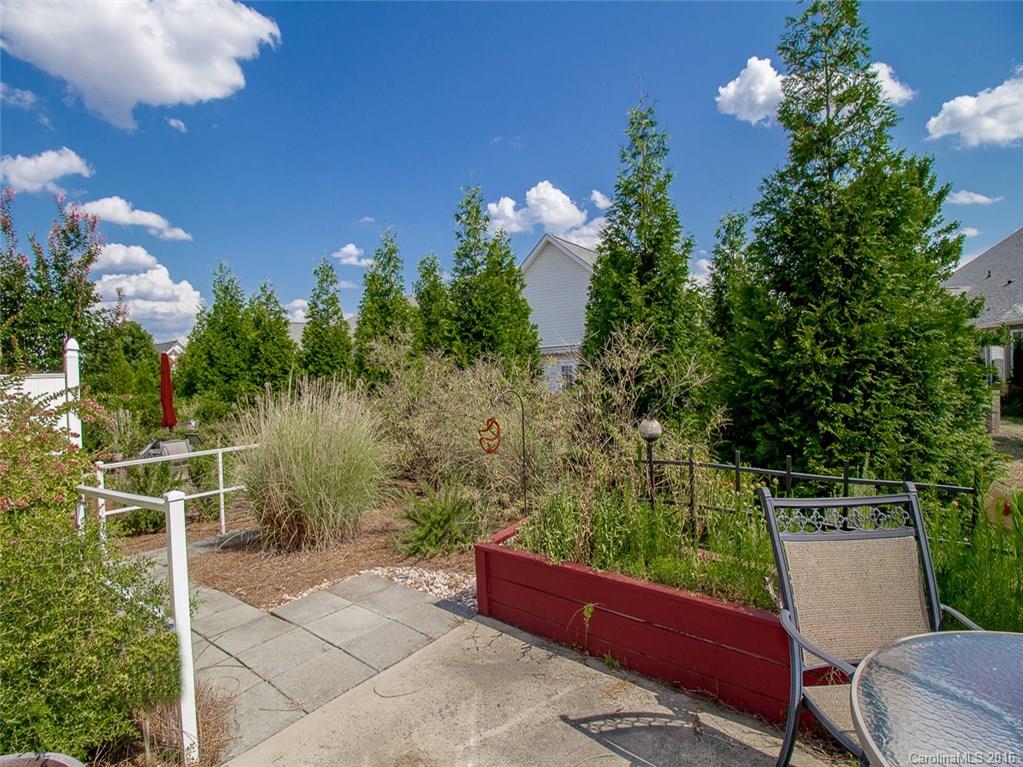219 Garnet Court, Unit 558 Fort Mill, SC 29708 - Photo 22 of 23 a view of a chair and table in the backyard