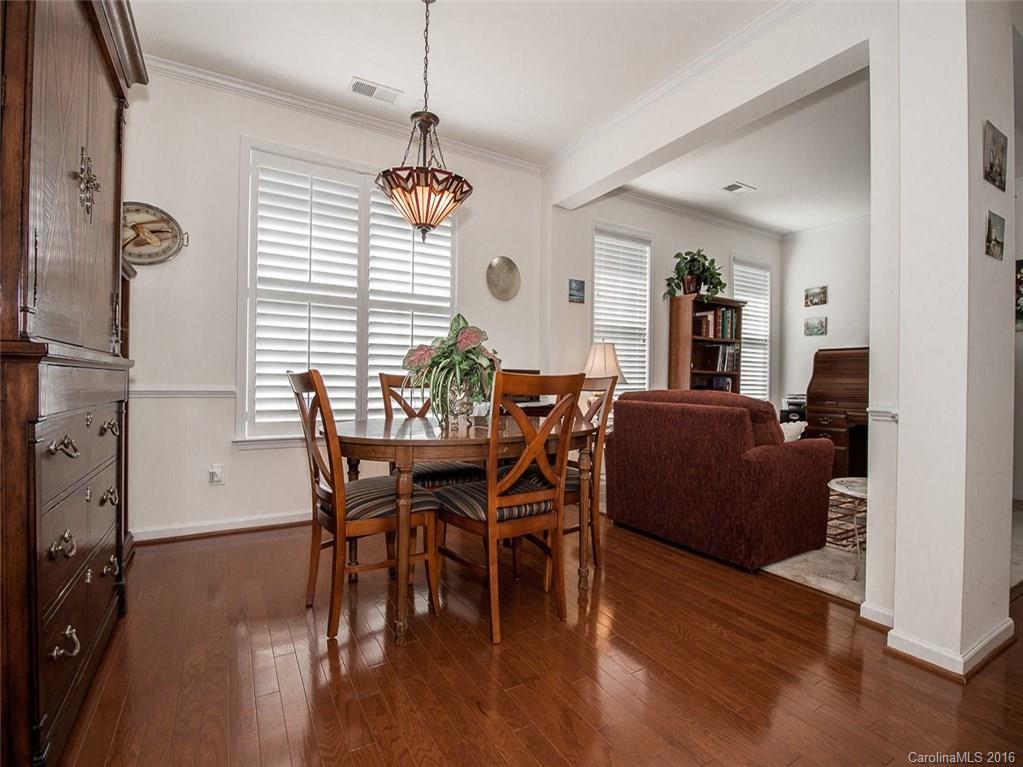 219 Garnet Court, Unit 558 Fort Mill, SC 29708 - Photo 7 of 23 a view of a dining room with furniture window and wooden floor