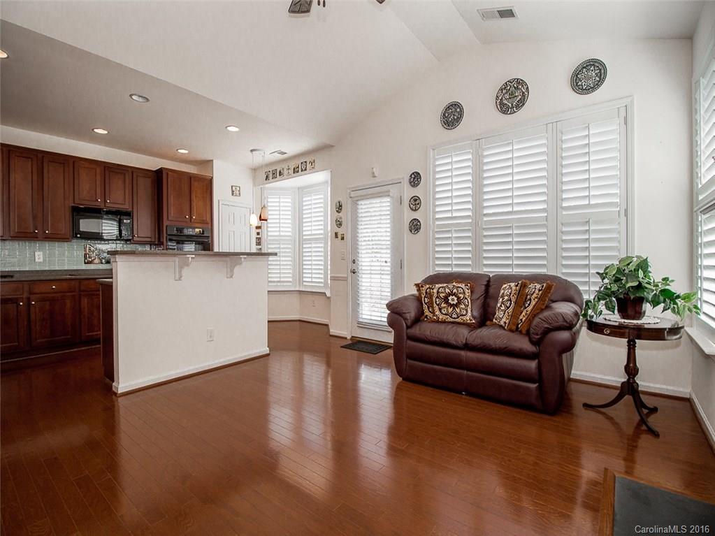 219 Garnet Court, Unit 558 Fort Mill, SC 29708 - Photo 9 of 23 a living room with furniture wooden floor and a kitchen view