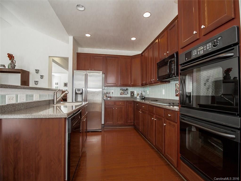 219 Garnet Court, Unit 558 Fort Mill, SC 29708 - Photo 10 of 23 a kitchen with stainless steel appliances granite countertop a sink a stove and a refrigerator