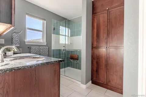 a bathroom with a granite countertop sink and a mirror