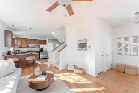 a living room with furniture and a kitchen