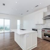 a kitchen with a stove and a wooden floors