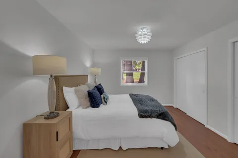 a bedroom with a bed and a lamp