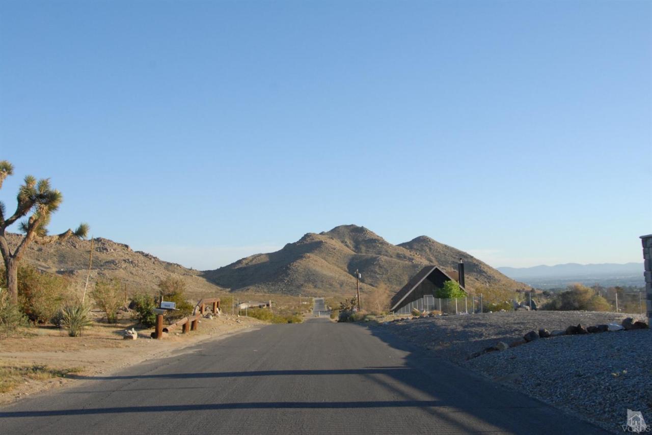 Roanoke Road Apple Valley, CA 92307 - Photo 1 of 7 a view of the house and mountains