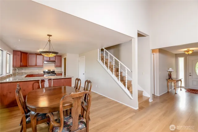 a kitchen with stainless steel appliances granite countertop wooden cabinets and a stove top oven