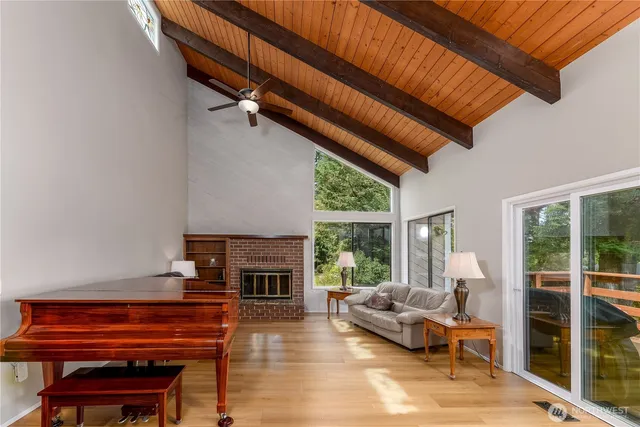 a living room with furniture a fireplace and a potted plant