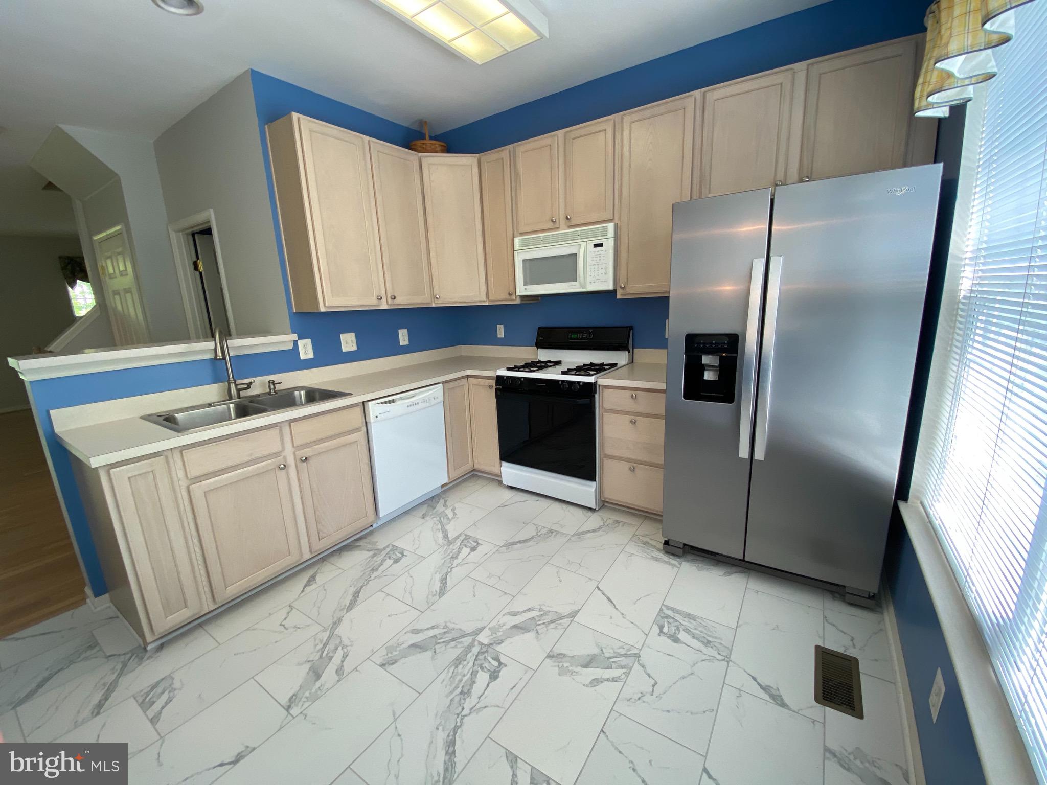 4110 Flower Fairfax, VA 22030 - Photo 13 of 64 a kitchen with a sink a refrigerator and cabinets