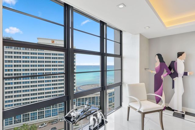 a view of a living room and a balcony