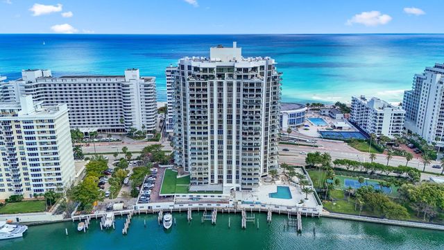 a living room with furniture and large windows